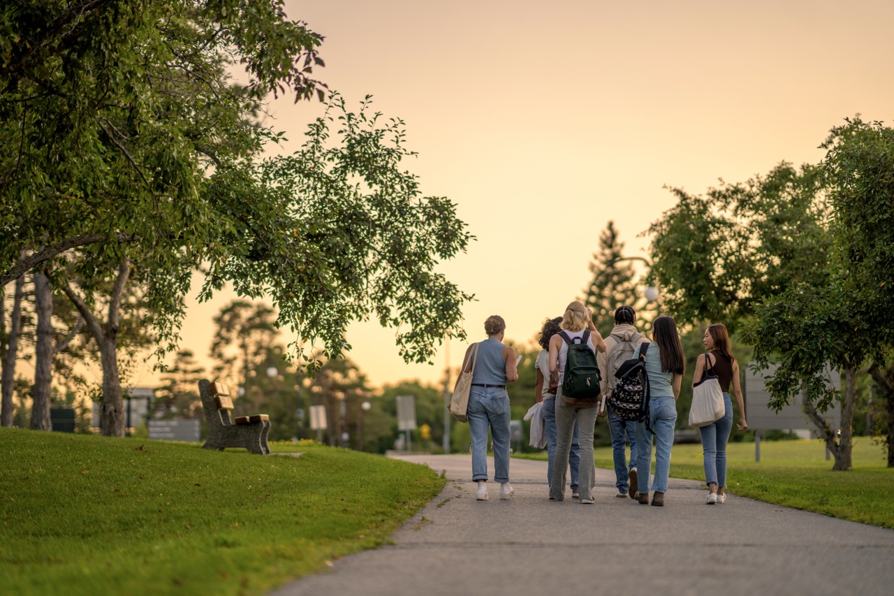 Students walking across campus at sunset